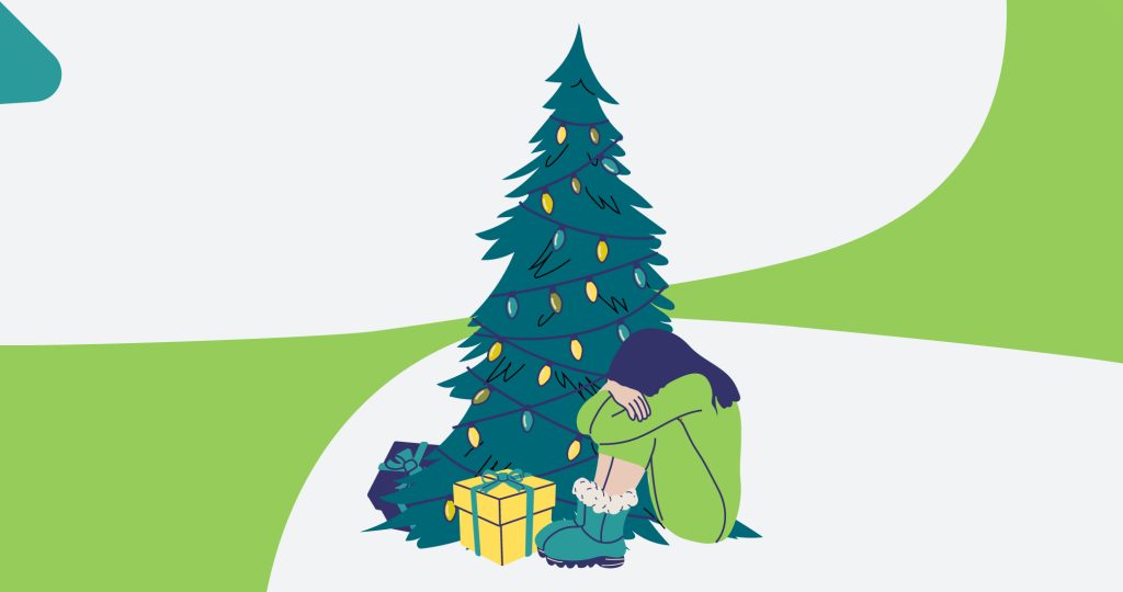 Ilustración de una joven sentada junto a un árbol de Navidad y sus regalos, con la cabeza escondida entre los brazos, para hablar del duelo en Navidad.